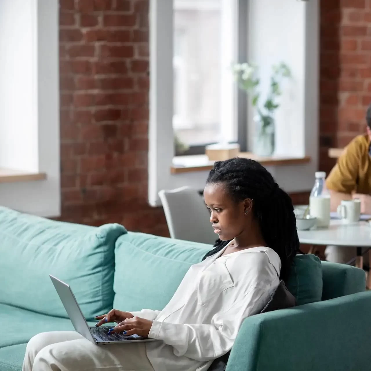 Woman on laptop in loft space